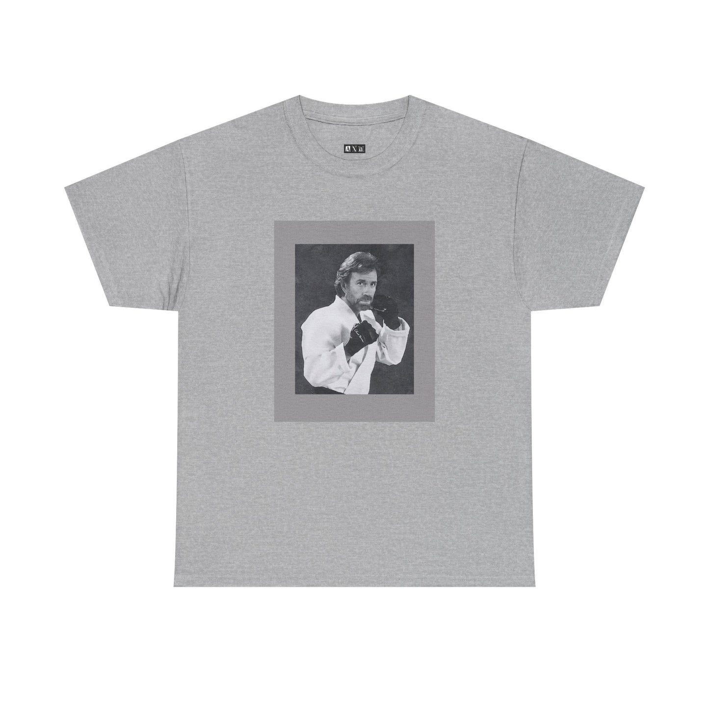 Chuck Norris unisex heavyweight tee shirt featuring a fierce fighting stance, frozen in black-and-white glory. A tribute to raw strength and unshakable legend, it’s more than a shirt—it’s a statement of fearless dominance.