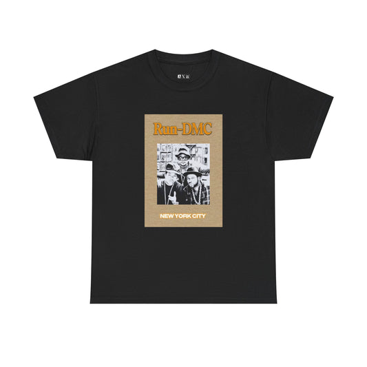 Run-DMC unisex heavyweight tee shirt featuring the iconic group posing in classic streetwear, topped with bold orange "Run-DMC" lettering and “NEW YORK CITY” stamped below. A tribute to one of hip-hop’s greatest pioneers.