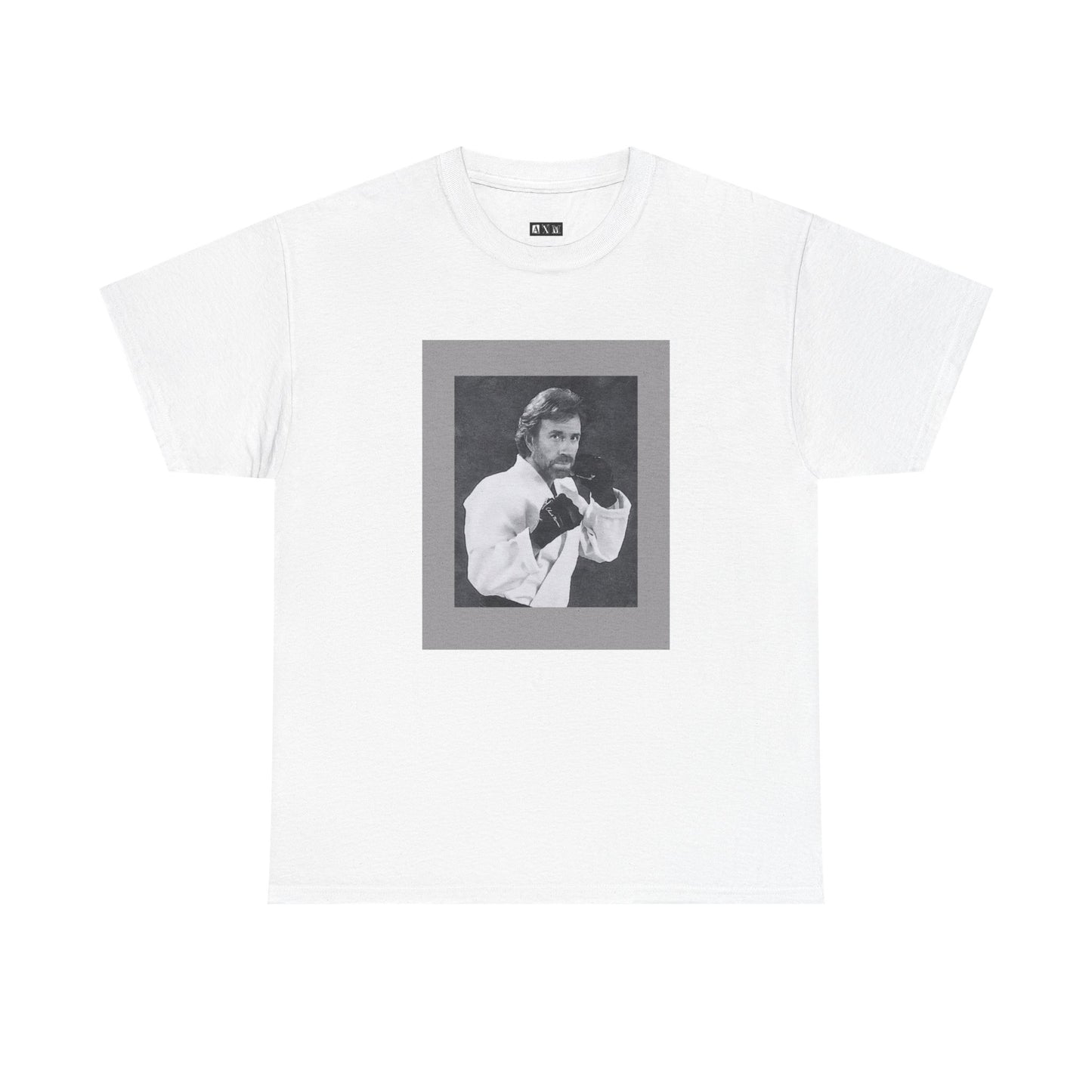 Chuck Norris unisex heavyweight tee shirt featuring a fierce fighting stance, frozen in black-and-white glory. A tribute to raw strength and unshakable legend, it’s more than a shirt—it’s a statement of fearless dominance.