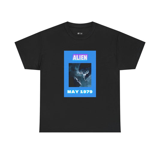 Alien unisex heavyweight tee shirt. A chilling tribute to Ridley Scott’s sci-fi horror masterpiece, capturing the fateful encounter of human and xenomorph, framed in neon tones with “ALIEN” and “MAY 1979.” Wear the terror that redefined cinema.