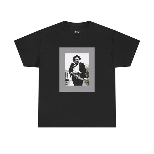 Leatherface black unisex heavyweight tee shirt. Chainsaw in hand, frozen mid-charge—an iconic, chilling tribute to horror’s most infamous figure. Perfect for those who embrace fear with a fearless style.